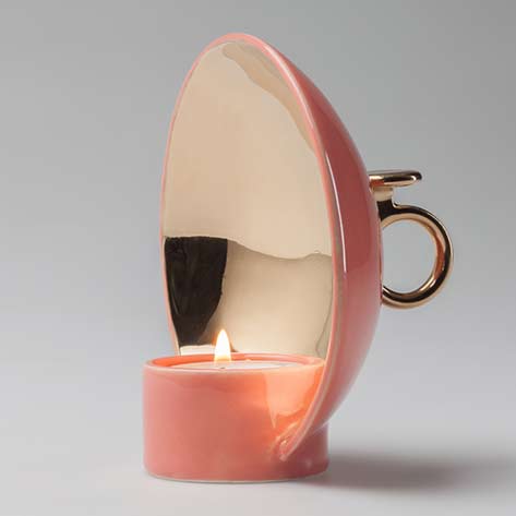Salmon-pink-candleholder-with-gold-details-called-lume-by-alessandro-zambelli-looks-like-a-satellite-dish