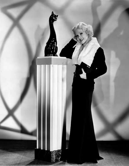 Alice-Faye-1935 with black cat sculpture on a pedestal