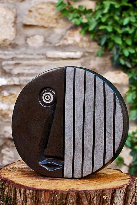 Eyewitness'-by James Mapayi flat round face sculpture