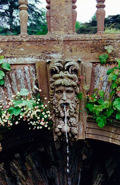 Hestercombe Gardens Arch Fountain - water running from a classical head sculpture