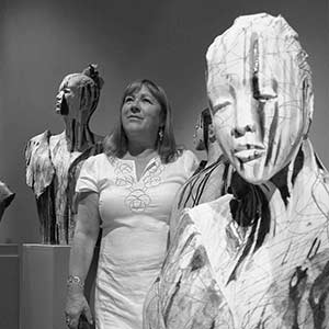 ann-goodfellow posing with her sculptures