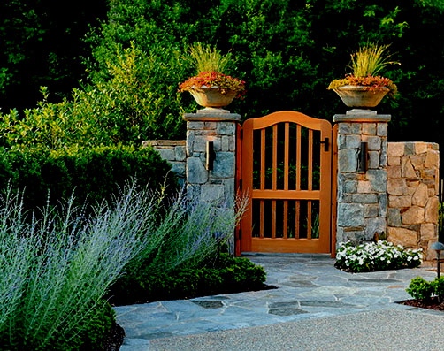 matching saucer pots framing garden gate