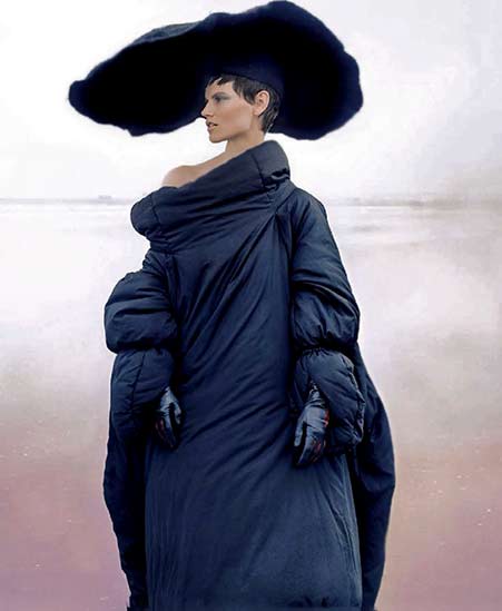 Model wearing a large black head piece and gownVogue-China-September-2014