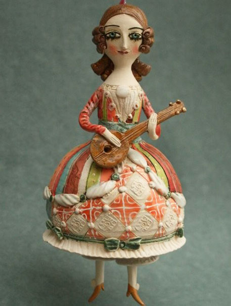 Young-girl-playing-mandolin.-Ceramic-bell,-sculpture.
